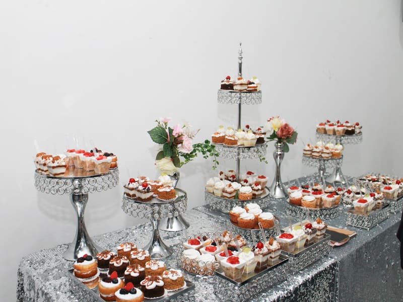 Dessert table of individually portioned cakes and cupcakes for an office event at The Bakest, Okhla
