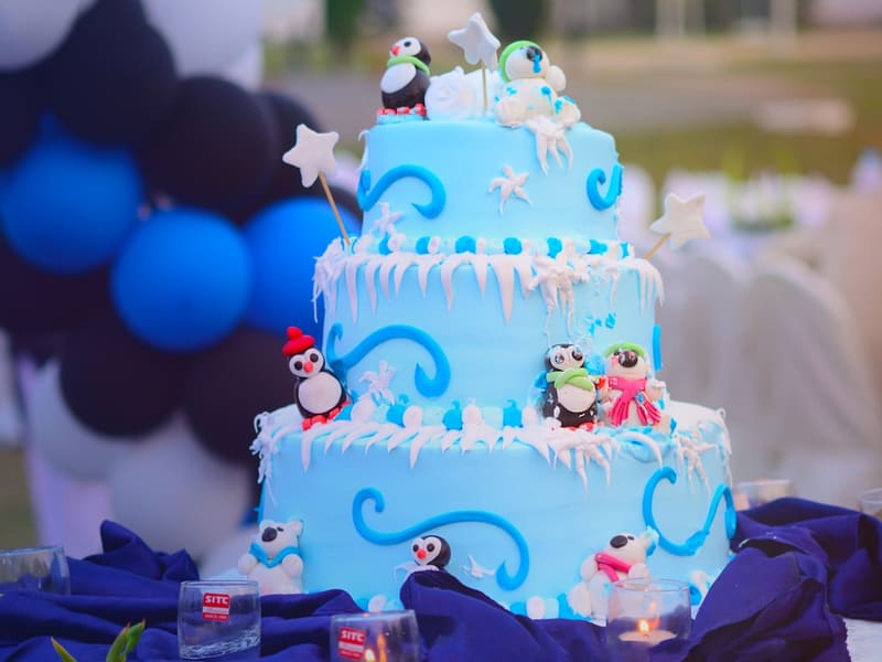 Two-tier theme cake with sculpted figures for a kids party at The Bakest, Okhla